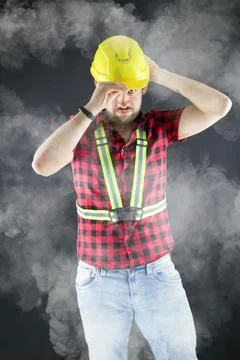 Construction Worker  in a dusty environment. Stock Photos
