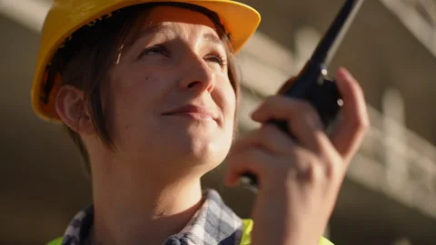 A construction worker effectively communicating via radio while actively working Stock Footage 311862836