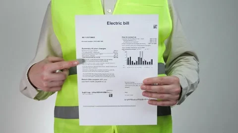 A construction worker with an energy saving light bulb and an energy bill Stock Footage 311540801