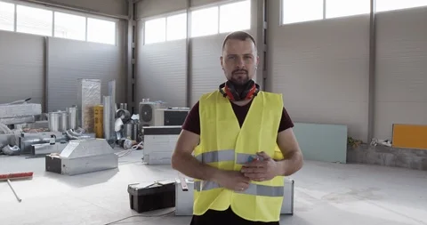 A construction worker, engineer, architect who looks straight to the camera. Video stock 127031903