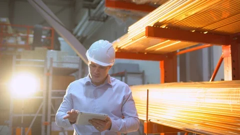 Construction worker engineer with tablet computer walking on factory Stock Footage 102741049