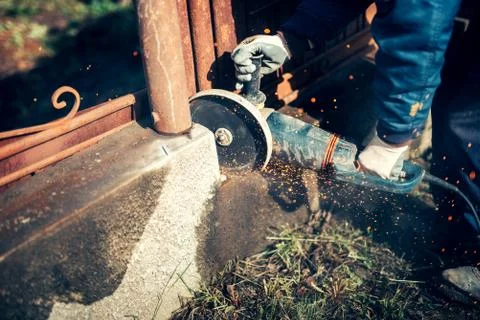 Construction worker, engineer using handy circular saw for cutting reinforced Stock Photos