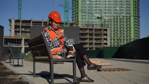 A Construction Worker is Enjoying a Relaxing Break at the Job Site Amidst Stock Footage 311860188