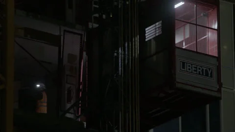 Construction Worker Entering Hoist Elevator at Night Stock Footage 344612859