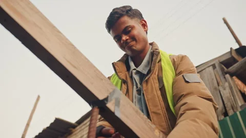 Construction worker evaluates beam alignment carefully. Experienced worker Stock Footage 334954497