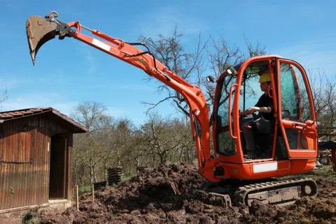 Construction worker in an excavator Stock Photos