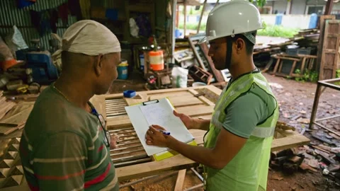 Construction Worker explains Plan to staff in workshop Stock Footage 297600483