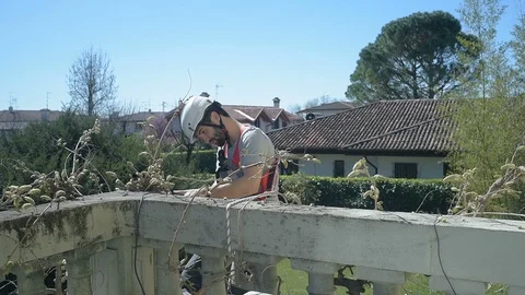Construction worker exterior using electric drill tool on altitude  Stock Footage 106041668