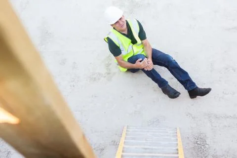 Construction Worker Falling Off Ladder And Injuring Leg Stock Photos