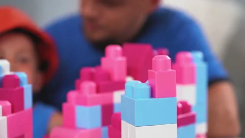 Construction worker father with his son wearing construction helmets playing Stock Footage 131595403