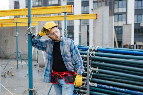 Construction worker feeling tired at building site Stock Photos