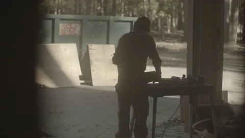 Construction worker fiddles with his tools in the garage Video stock 146197541