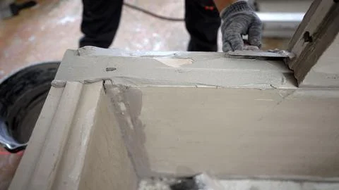 Construction worker finishing cement surface with precision tool 스톡 사진