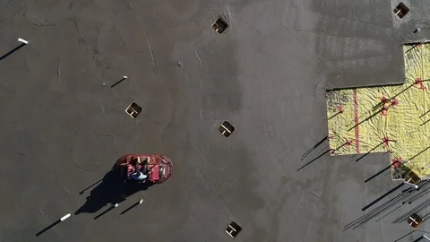 Construction Worker Finishing an Industrial Concrete Slab Using a Ride on Stock Footage