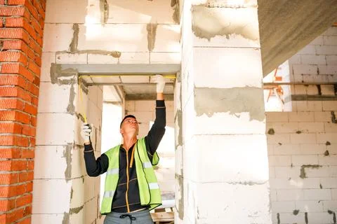 Construction worker fits ceiling panels, attaches supports, technical inspe.. Stock Photos