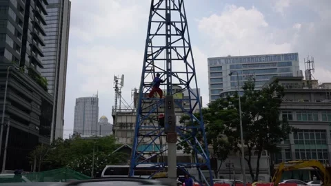 Construction worker fixing cabling on a crane in Bangkok, Thailand. Stock Footage 240914255