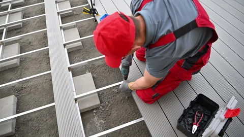 Construction Worker Focused on Outdoor Decking Installation Stock Footage 274307254