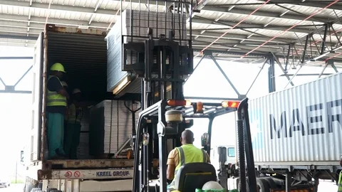 Construction worker in forklift truck unloading cargo Stock Footage 143774304