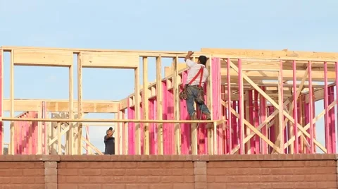 Construction Worker Framing a new House in a Neighborhood Stock Footage 50084800