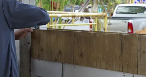 Construction worker framing a wall at a job site urban area series outdoor Stock Footage 332928179