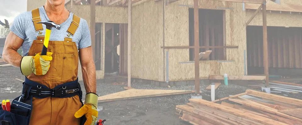 Construction Worker in front of construction site. A carpenter while standing Stock Photos