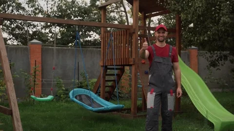 Construction worker gesturing positively by playground equipment Stock-Footage 289827580