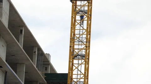Construction worker going down the crane Stock Footage 80773249