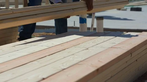 Construction Worker Grabs Lumber from Pile Stock Footage 80832924