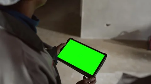 Construction Worker with Green Screen Tablet Looking at Concrete Wall Stock Footage 320674873