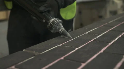 Construction worker grouting in between tiles, Mansfield, Nottinghamshire, UK Stock-Footage 155058076