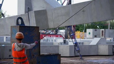 Construction worker guiding concrete beam with rope Stock Footage 314969090