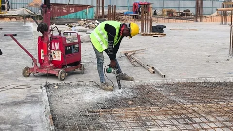 Construction Worker Hacking Concrete Slab with Power Tool Stock Footage 336328304