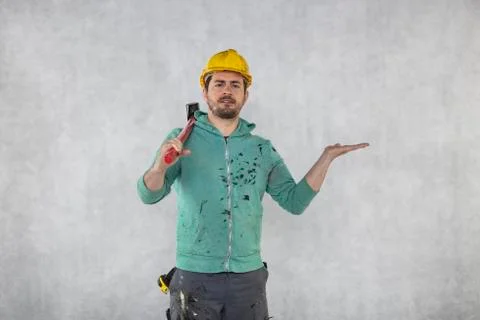 Construction worker with a hammer in hand, concept of construction and disass Stock Photos