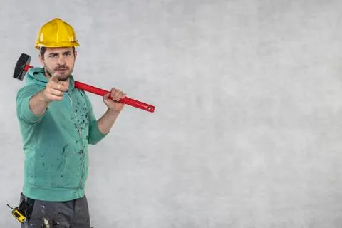 Construction worker with a hammer in hand, concept of construction and disass Stock-Fotos