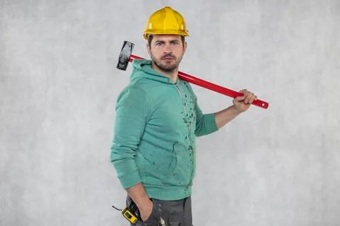 Construction worker with a hammer in hand, concept of construction and disass Stock-Fotos