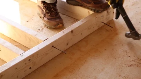 Construction Worker Hammering a Nail into a Frame Stock Footage 81751631