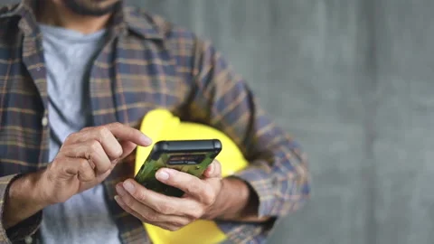 Construction worker hands using smartphone Stock Footage 138808700