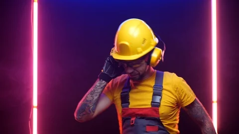 A construction worker in a hard hat listens to music Stock Footage 125926243
