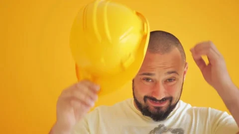 Construction worker in a hard hat on a yellow background Video stock 200942154