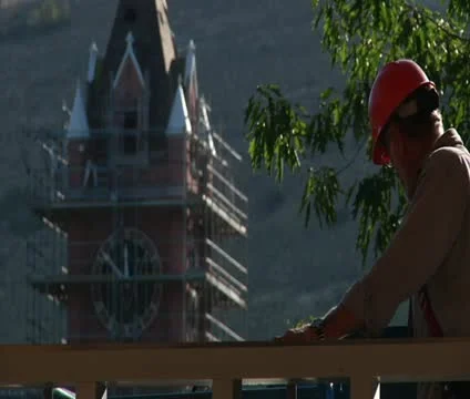 Construction worker with hardhat and clock tower Stock Footage 21560982