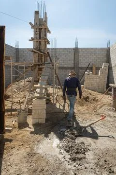 Construction worker in hardhat holding up plank at site Stock Photos