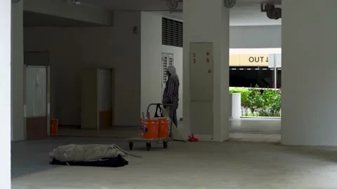 Construction worker at HDB void deck in Singapore, renovations work ongoing Stock Footage 162009907