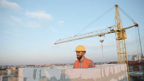Construction worker on high-rise site wearing safety helmet Stock Footage 286050294