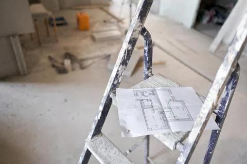 The construction worker hold in hands Architectural blueprints. Repair or Stock Photos
