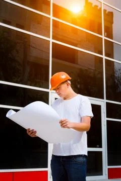 Construction worker hold plan of the building Stock Photos