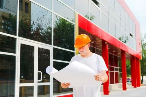 Construction worker hold plan of the building Stock Photos
