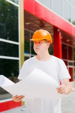 Construction worker hold plan of the building Stock Photos