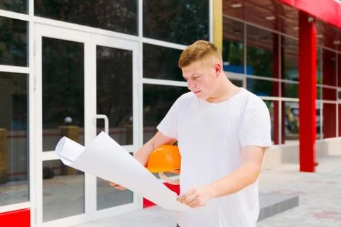 Construction worker hold plan of the building Stock Photos