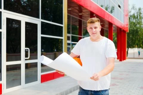 Construction worker hold plan of the building Stock Photos