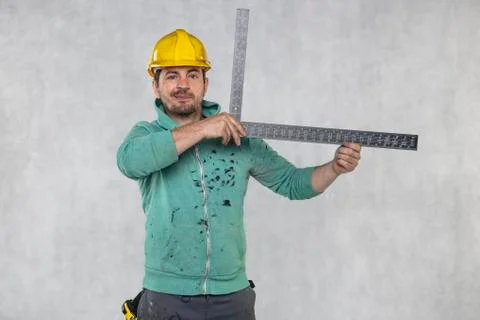 The construction worker is holding a angle in the hand, a guide to constructi Stock Photos